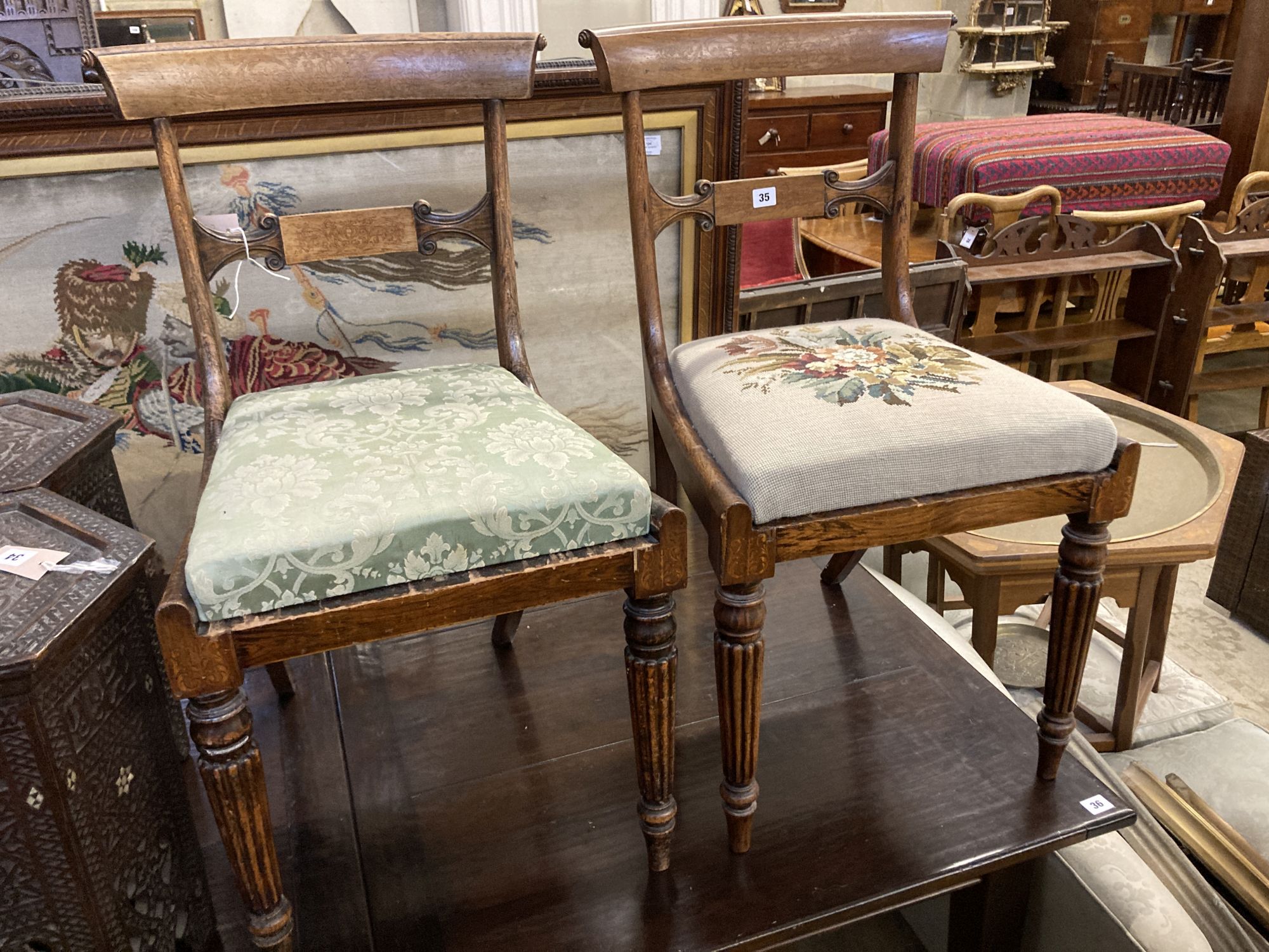 A pair of William IV simulated rosewood dining chairs, with curved marquetry inlaid crest rails and spars, over tapestry drop in seats